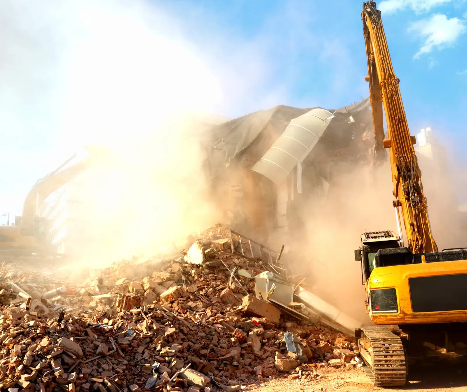 Excavator tearing down a building on a demolition job